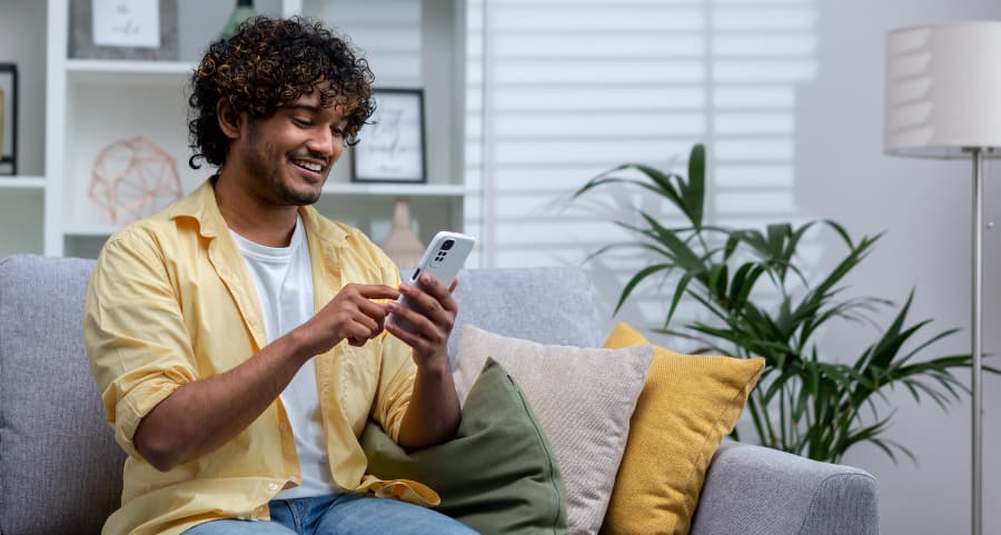 Homeowner accessing a home security app on his mobile device